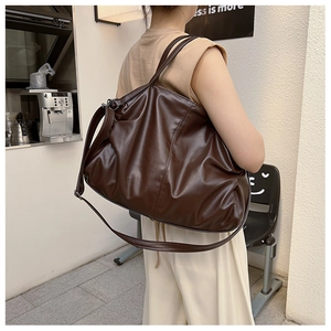 Detail of dark brown large tote bag in soft lychee grain leather for commuting