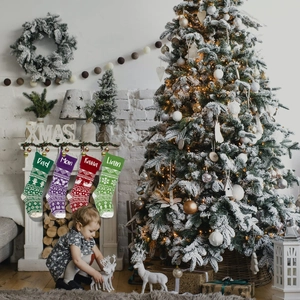 Detailed knit Christmas stocking set with personalized names and festive Nordic patterns