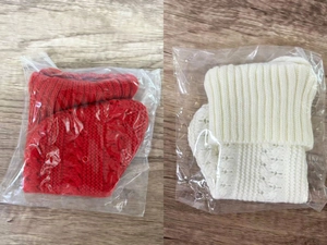 Detailed knit texture of thick red and cream Christmas socks in protective packaging