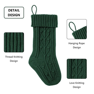 Detailed close-up of dark green knitted Christmas stocking texture and hanging loop
