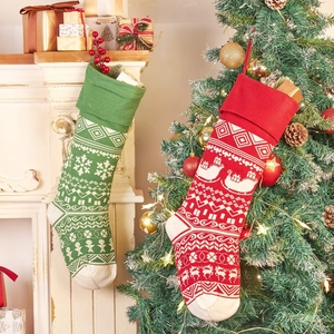Knitted Christmas stockings with reindeer and snowflake patterns in red and green set