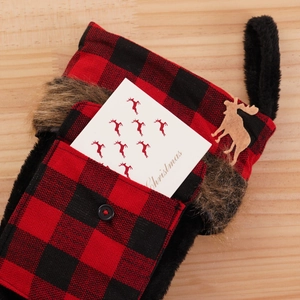 Red and black buffalo plaid Christmas stocking with plush trim and wooden elk ornament