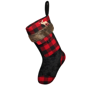 Detail of red and black buffalo plaid Christmas stocking with faux fur and reindeer patch