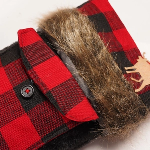 Close-up of red and black buffalo plaid fabric with faux fur trim and elk wood button