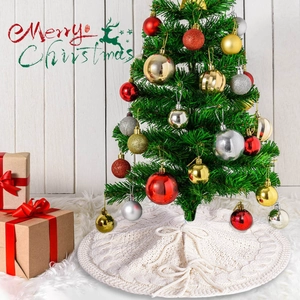 Detail of off-white cable knit Christmas tree skirt with decorative tie closure