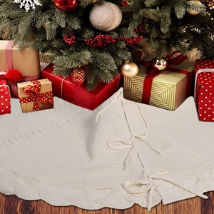 Detaillierte Stricktextur von cremeweißem Weihnachtsbaumrock mit Wellenspitze und Bändern