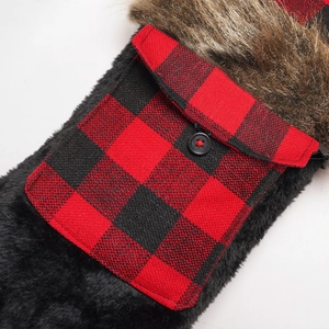 Detail of black plush fabric with red buffalo plaid pocket and brown faux fur trim