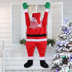 Outdoor festive Christmas climbing Santa Claus decoration on white window display