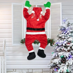 Outdoor climbing Santa Claus decoration on white window with festive snowy tree