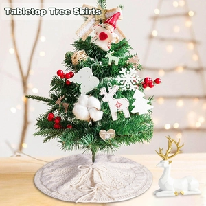 Cream knit tabletop Christmas tree skirt with cable pattern and festive bow tie