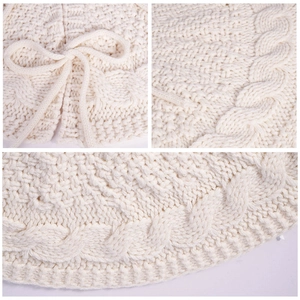 Close-up of cream cable knit texture and decorative bow tie on a soft knitted garment