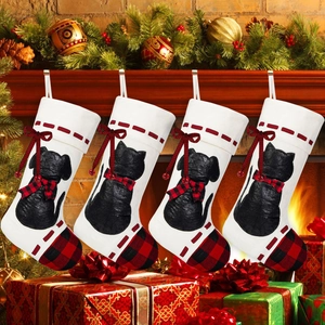 Set of four cream Christmas stockings with black dog silhouette and red buffalo plaid bow