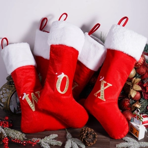 Classic red Christmas stockings with white plush cuff and gold sequin letter embroidery