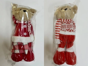 Detail of Christmas teddy bears in red winter outfits and plaid holiday accessories