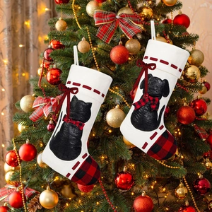 Close-up of black pet silhouettes on festive Christmas stockings with red plaid accents