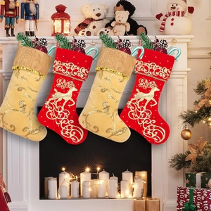 Detail of hanging Christmas stockings with golden reindeer patterns and sequined trim