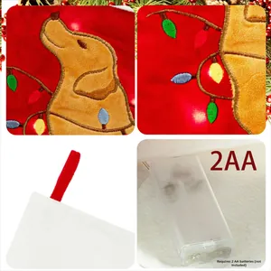 Macro shot of red Christmas stocking with golden retriever embroidery and LED battery pack