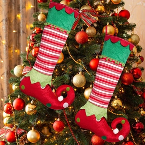 Christmas elf socks set with red white stripes and curved toe hanging on a decorated tree