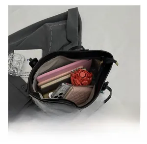 Spacious black canvas tote with tweed details showing internal tablet storage