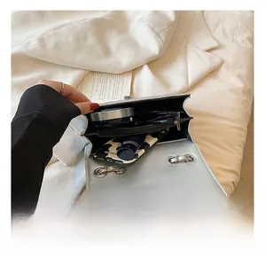 Detailed view of the silver quilted chain bag interior with multi-layer compartments