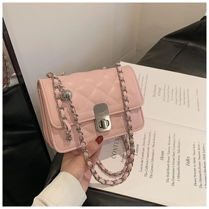 Detail showing pink quilted leather texture and silver metal chain strap on a flap bag