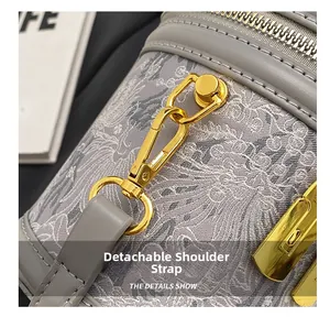 Detail showing the golden metal hook and detachable shoulder strap on the grey bucket bag
