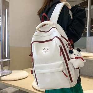 Cream large capacity school backpack with burgundy trim and plush dog pendant