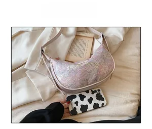 Detailed macro view of the abstract oil painting texture on a crescent shoulder bag