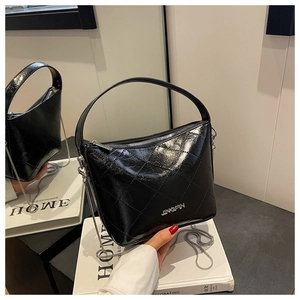 Detail of black quilted leather bucket bag with metal chain strap and JINGPIN logo