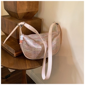 Detail of lavender jacquard crescent bag with leather logo and beaded charm