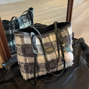 Large black and white checkered canvas tote bag with slim shoulder straps and pearl charm