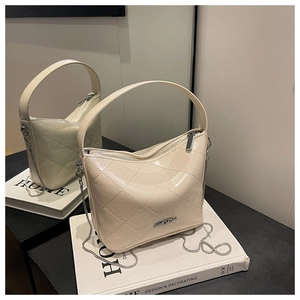 Close-up of cream quilted bucket bag with chain strap and silver JINGPIN metal logo