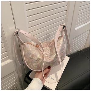 Detail of pink floral jacquard bag with AIDGEE logo and adjustable leather strap