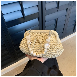 Detail of woven straw handbag featuring vintage marble beads and silver metal clasp closure