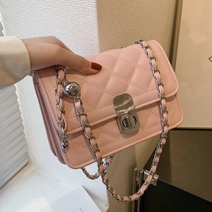 Pink quilted chain crossbody bag with metallic ball strap and silver turn-lock closure