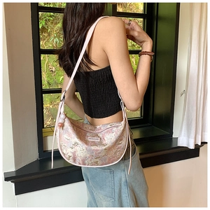 Pink jacquard crescent bag with delicate pearl charms and silver brand label detail