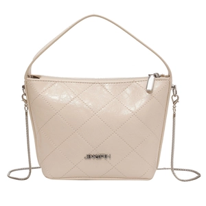 Beige quilted chain bucket bag with silver hardware and top handle for women