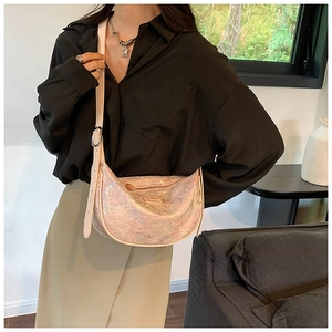 Pink iridescent marble texture hobo bag with adjustable strap shown in modern indoor setting