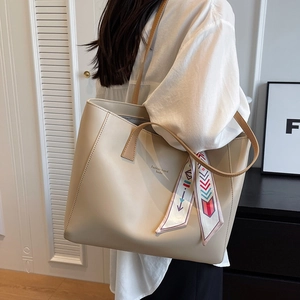 Minimalist beige large capacity tote bag with decorative silk scarf on the handle