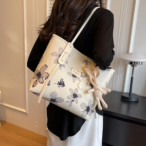Large floral canvas tote bag with rabbit charm shown on model in cozy interior