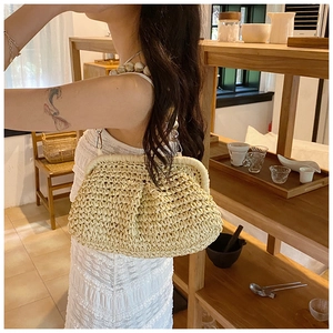 Detail of hand-woven cream crossbody bag featuring a unique wooden bead shoulder strap