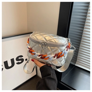 Detail of silver quilted waist bag with multi-color chain link and wide fabric strap
