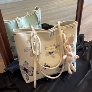 White canvas tote bag with black floral sketch and cute pink bunny pendant