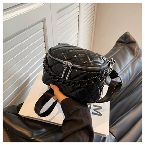 Close-up of black quilted leather waist bag with thick chain and silver zippers