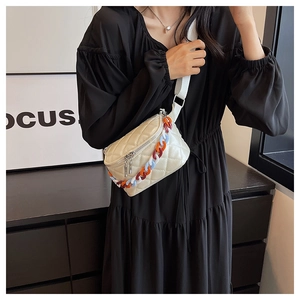 Quilted off-white waist bag with colorful resin chain and canvas strap on model