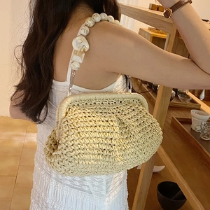 Chic cream straw cloud tote bag featuring elegant marble beaded handle for summer beach fashion
