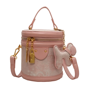 Pink cylinder bucket bag with phoenix floral pattern and dog charm accessories