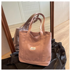 Pink canvas tote bag showing large capacity structure and front rectangular patch pocket