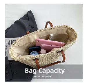 Internal view of straw tote bag showing large capacity, zipper pocket, and leather handles