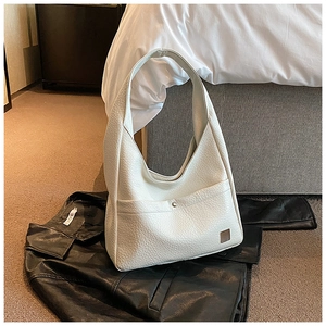 Close-up of white lychee texture leather shoulder bag with metallic bead detail and logo